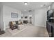 Relaxing bonus room offers comfortable seating, neutral carpeting, and convenient access to an attached bathroom at 6438 Hove Rd, Mint Hill, NC 28227