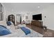 Bright living room with a large TV, stylish decor, and an arched doorway for added character and charm at 6438 Hove Rd, Mint Hill, NC 28227