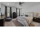 Bright bedroom features a luxurious bed, stylish furniture, and large windows with elegant window treatments at 6438 Hove Rd, Mint Hill, NC 28227