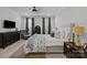 Bright bedroom features a luxurious bed, stylish furniture, and large windows with elegant window treatments at 6438 Hove Rd, Mint Hill, NC 28227