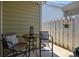Cozy patio with charming table and chairs and privacy fence with a decorative hanging flower pot at 6438 Hove Rd, Mint Hill, NC 28227