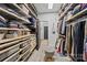 Spacious walk-in closet with custom shelving, storage bins, a stool, and carpet at 6438 Hove Rd, Mint Hill, NC 28227