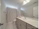 Bathroom featuring a large vanity with modern fixtures, and a shower with decorative shower curtain at 647 R L Stowe Rd, Belmont, NC 28012