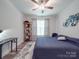 This bedroom features a ceiling fan, large windows, and hardwood floors at 647 R L Stowe Rd, Belmont, NC 28012