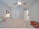 Bright bedroom featuring a ceiling fan, neutral paint, and double closets at 647 R L Stowe Rd, Belmont, NC 28012