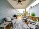 Relaxing covered porch with outdoor seating, ceiling fan, and backyard view at 647 R L Stowe Rd, Belmont, NC 28012