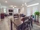 Spacious dining area features a dark wooden table with an open view of the living room and access to the patio at 647 R L Stowe Rd, Belmont, NC 28012