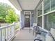 Inviting front porch with seating, stylish decor, and charming curb appeal at 647 R L Stowe Rd, Belmont, NC 28012