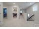 Hallway with laundry room, stairs, and access to bedrooms with neutral tones at 647 R L Stowe Rd, Belmont, NC 28012