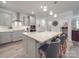 Well-lit kitchen features granite countertops, stainless steel appliances, and a kitchen island with seating at 647 R L Stowe Rd, Belmont, NC 28012