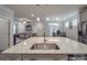 Open-concept kitchen with stainless steel appliances, an island, and granite countertops overlooks the living and dining areas at 647 R L Stowe Rd, Belmont, NC 28012