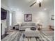 Cozy living room featuring a modern sofa, fireplace, ceiling fan, and neutral decor at 647 R L Stowe Rd, Belmont, NC 28012
