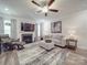 Comfortable living room features a fireplace, ceiling fan, and neutral color palette at 647 R L Stowe Rd, Belmont, NC 28012