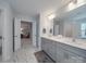 Well-lit bathroom with double sinks, gray cabinetry, and modern marble tile floors at 647 R L Stowe Rd, Belmont, NC 28012