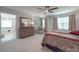 Spacious main bedroom featuring a ceiling fan, sitting area, and en-suite bathroom at 647 R L Stowe Rd, Belmont, NC 28012