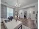 Bright office space with natural light, modern furnishings, and an adjoining hallway leading to other rooms at 647 R L Stowe Rd, Belmont, NC 28012