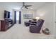 Cozy sitting room features a ceiling fan, TV, plush seating and soft carpeting at 647 R L Stowe Rd, Belmont, NC 28012