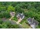 An aerial view shows a well-maintained property with lush landscaping, mature trees and neighborhood setting at 6632 Hawksnest Dr, Charlotte, NC 28269