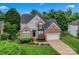An inviting two-story home with lush greenery, a two-car garage, and a well-kept lawn at 6632 Hawksnest Dr, Charlotte, NC 28269