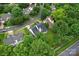 An aerial view shows a well-maintained property with lush landscaping and a private backyard at 6632 Hawksnest Dr, Charlotte, NC 28269