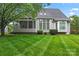 Exterior view of home featuring a screened porch and a lush, manicured lawn at 6632 Hawksnest Dr, Charlotte, NC 28269