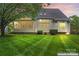 Spacious backyard with lush green lawn, screened porch, and mature trees, perfect for outdoor living and entertaining at 6632 Hawksnest Dr, Charlotte, NC 28269