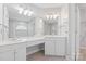 Bathroom featuring double sinks, large vanity, and decorative lighting fixtures at 6632 Hawksnest Dr, Charlotte, NC 28269