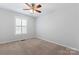 Bedroom featuring neutral walls, ceiling fan, carpet flooring, and a window with blinds at 6632 Hawksnest Dr, Charlotte, NC 28269