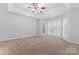 Spacious bedroom features plush carpeting, ample natural light, and ceiling fan at 6632 Hawksnest Dr, Charlotte, NC 28269