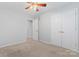 Bedroom featuring neutral walls, ceiling fan, carpet flooring, and closet with paneled doors at 6632 Hawksnest Dr, Charlotte, NC 28269