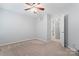 Bedroom with plush carpeting, neutral walls, and ceiling fan at 6632 Hawksnest Dr, Charlotte, NC 28269
