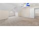 Spacious bonus room with vaulted ceilings, plush carpeting, and a arched window at 6632 Hawksnest Dr, Charlotte, NC 28269