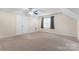 Spacious bonus room with vaulted ceilings, plush carpeting, and a closet with paneled doors at 6632 Hawksnest Dr, Charlotte, NC 28269