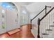 Inviting foyer with hardwood floors, a staircase, decorative window and an arched doorway at 6632 Hawksnest Dr, Charlotte, NC 28269