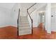 Bright foyer featuring hardwood floors, a staircase with wood railings, and elegant trim details throughout at 6632 Hawksnest Dr, Charlotte, NC 28269