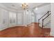 Bright foyer featuring hardwood floors, chandelier, staircase, and lots of natural light at 6632 Hawksnest Dr, Charlotte, NC 28269