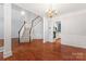 Spacious foyer features hardwood floors, a staircase, and views into the dining and kitchen areas, great for entertaining at 6632 Hawksnest Dr, Charlotte, NC 28269