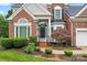 Lovely brick home featuring a manicured front yard, two-car garage, and tasteful landscaping for a charming appeal at 6632 Hawksnest Dr, Charlotte, NC 28269