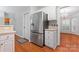 Kitchen featuring stainless steel refrigerator, white cabinets, and wood floors at 6632 Hawksnest Dr, Charlotte, NC 28269