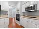 Kitchen featuring stainless steel oven, microwave, and white cabinets at 6632 Hawksnest Dr, Charlotte, NC 28269