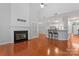 Cozy living room with fireplace, hardwood floors, and lots of natural light at 6632 Hawksnest Dr, Charlotte, NC 28269