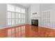 Living room featuring fireplace, hardwood floors, and lots of natural light at 6632 Hawksnest Dr, Charlotte, NC 28269