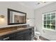 Bathroom with large window and dark vanity at 7213 Lancer Dr, Charlotte, NC 28226