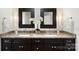 Stylish bathroom with dual sinks, granite countertop, and modern lighting fixtures at 7213 Lancer Dr, Charlotte, NC 28226