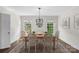 Formal dining room featuring elegant chandelier, large windows, and seating for six at 7213 Lancer Dr, Charlotte, NC 28226