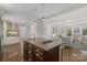 Open concept kitchen features a large island, stainless steel appliances, and seamless flow to living area at 7213 Lancer Dr, Charlotte, NC 28226