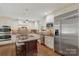 Bright kitchen boasts stainless steel appliances, a center island, and custom cabinetry at 7213 Lancer Dr, Charlotte, NC 28226