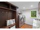 Laundry area with storage and bench seating near the washer and dryer at 7213 Lancer Dr, Charlotte, NC 28226