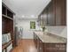Modern laundry room with washer, dryer, granite counters, and ample storage cabinets at 7213 Lancer Dr, Charlotte, NC 28226