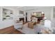 Cozy living room with a fireplace, built-in shelving, and an open view of the kitchen at 7213 Lancer Dr, Charlotte, NC 28226